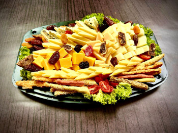 Plater of cheeses with dried fruit and breadcrumbs